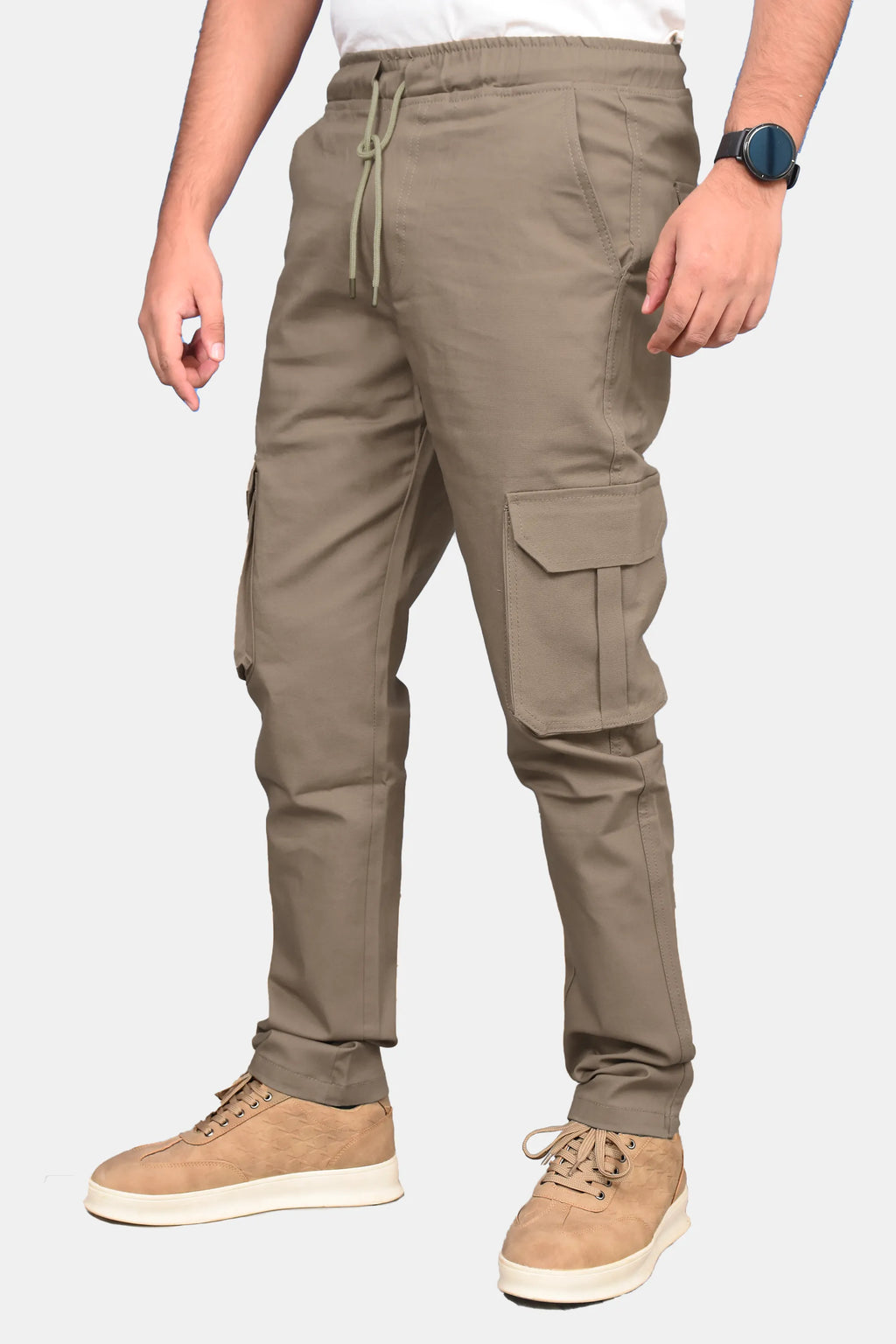 A person wearing khaki cargo jogger pants with a drawstring waist, shown from the waist down against a light gray background.