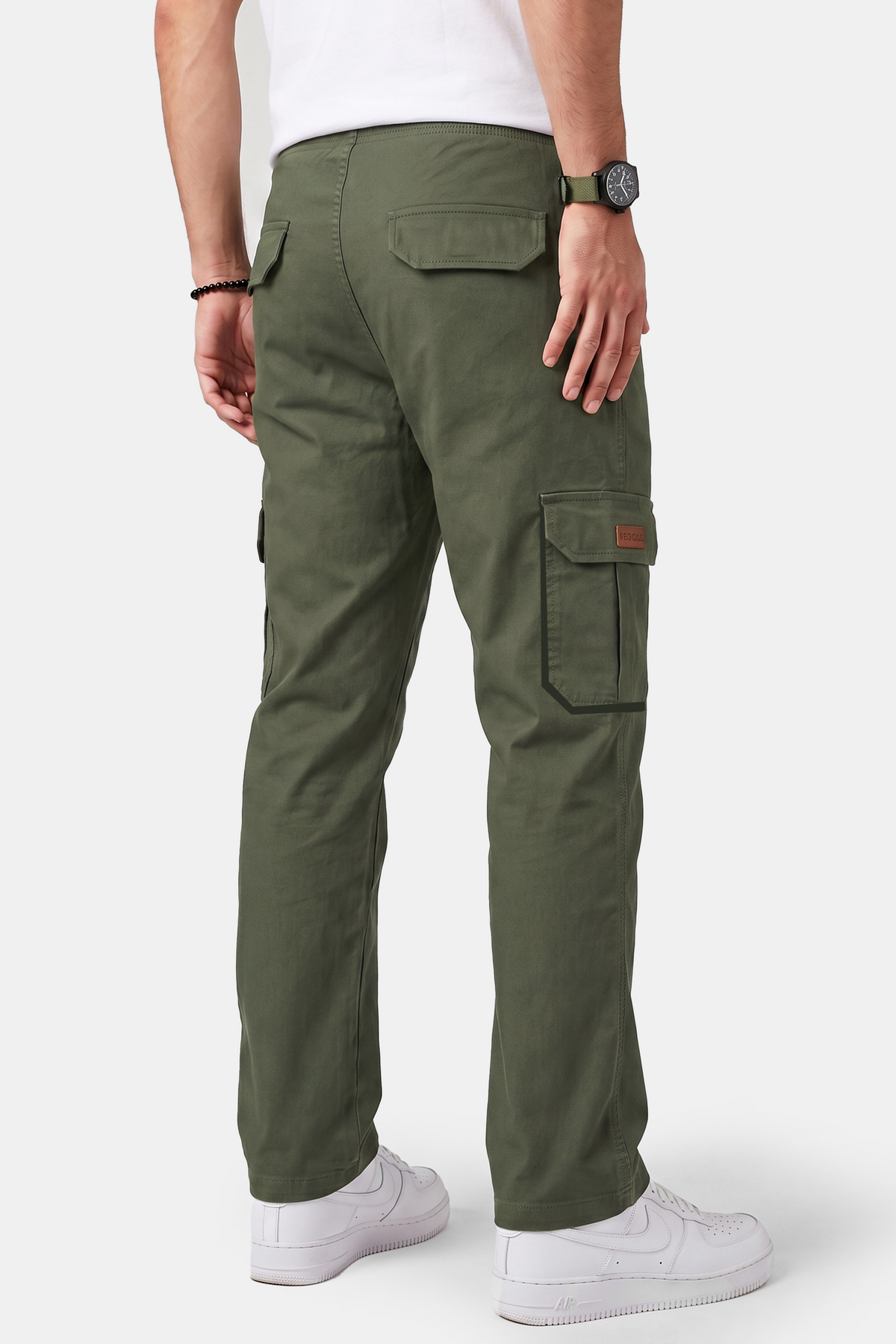 A man wearing olive green cargo pants, shown from the back. The pants feature multiple utility pockets, including a large cargo pocket on the right thigh.